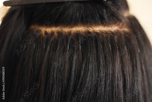Photos Young woman getting hair extensions in beauty salon, closeup