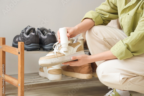 Woman polishing sneaker at ...
