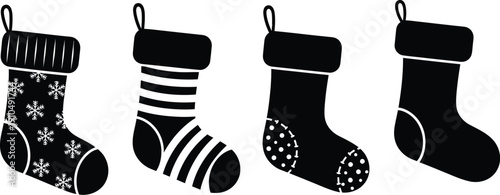 Collection of four stylized black and white holiday Christmas stockings featuring various classic seasonal patterns like snowflakes stripes and polka dots for decoration