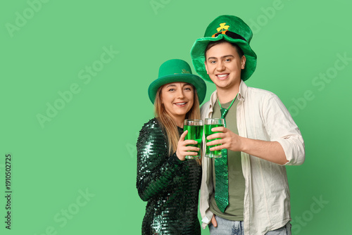 Happy friends with beer on green background. St. Patrick's Day celebration