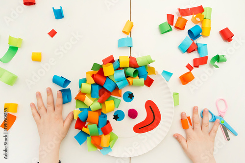 Paper plate clown. DIY games at home, activities for pre-school Kids. 5 minute crafts. Children joy and funny to cut a hair for clown. Red Nose Day theme.