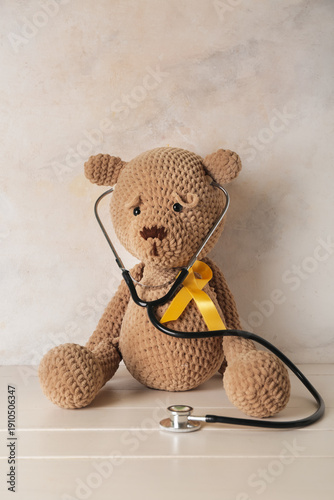 Toy bear with golden ribbon...