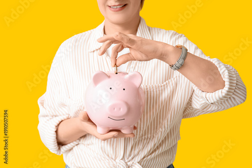 Mature woman putting coin i...