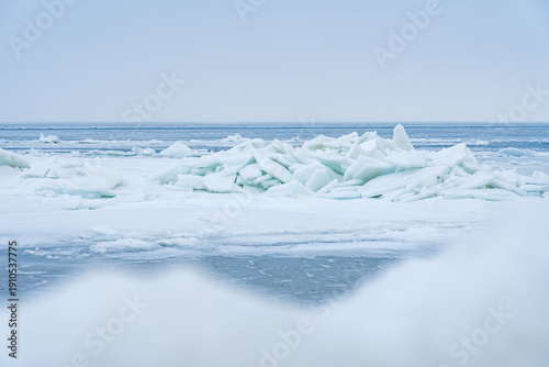 Stacked Ice Floes on the Baltic Sea with Blurry Ice in Foreground and Endless Blue Ice in Background