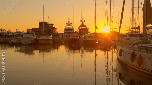 Sunset over serene port in Ventimiglia, Italy, with yachts docked