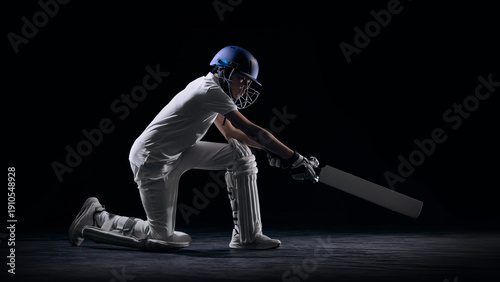 Quadro em tela Junior cricketer kneeling and playing defensive shot in studio