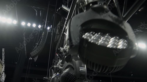 Beam frame with adjustable lighting equipment over stage closeup. Powerful spotlight lamps on support ready for installation in concert hall