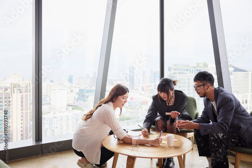 Male and female entrepreneurs planning strategies while sitting in modern office