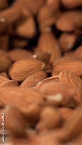 Slow Motion, Intricately Crafted Visual Capturing Almonds Flowing Out Of Sack Illuminated By Gentle Warm