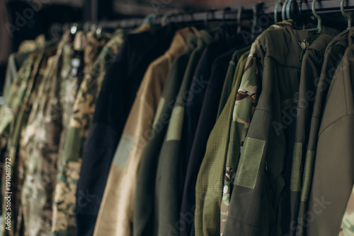 Foto Military surplus clothing hanging on a clothes rack
