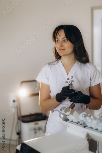 Cosmetologist holding facial machine working in beauty salon