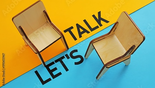 Chairs wooden miniature pair facing each other over yellow and blue background with LET'S TALK text, concept for conversation, therapy session, negotiation, meeting or interview