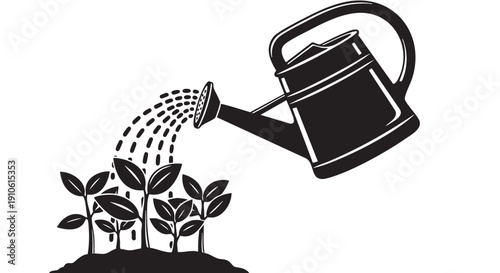 Watering can pouring water on plants in a garden from an overhead viewpoint