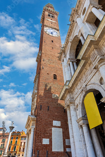 Wallpaper Mural Basilica Palladiana and Torre Bissara tower stand tall in Piazza della Signoria in Vicenza, Italy under a blue sky with scattered clouds Torontodigital.ca