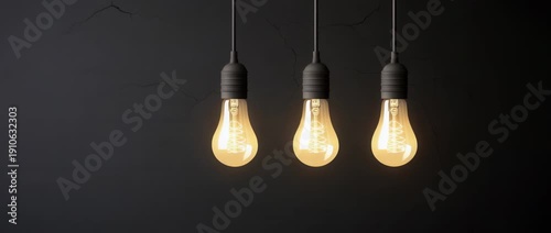 Three glowing vintage Edison light bulbs hang against  dark  wall space