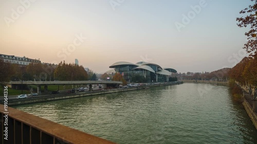 Stunning time-lapse of Tbilisi Public Service Hall building and Kura river during sunset. Transition from day to night with moving cars, boats and glowing city lights in the capital of Georgia