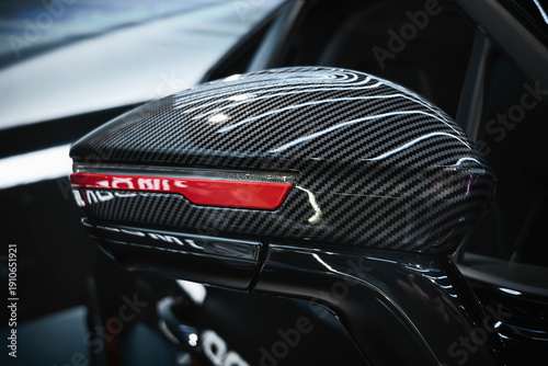 Automotive side mirror with carbon fiber housing, integrated LED turn signal repeater, and low-drag aerodynamic design