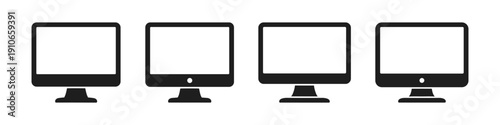 Collection of four modern computer monitors with blank screens and stands