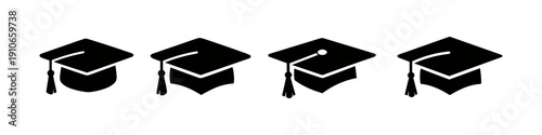 Collection of four black graduation caps with tassels on a white background