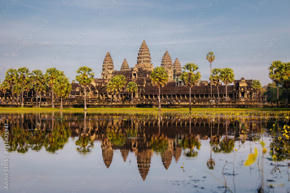 Fototapeta premium Angkor Wat temple reflected in water. Ancient civilization complex, cultural heritage landmark, historic architecture, and Southeast Asia travel destination. Siem Reap Cambodia.