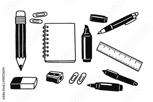 Black and white stationery set with notebook, pencil, pens, and ruler