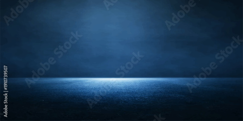 Dark blue grunge wall background with a subtle spotlight shining through mystical smoke and fog texture to create a vintage night sky design