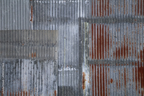 Artistic of old and rusty zinc sheet wall. Vintage style metal sheet roof texture. Pattern of old metal sheet. Rusting metal or siding. Corrosion of galvanized. Background and texture in retro concept
