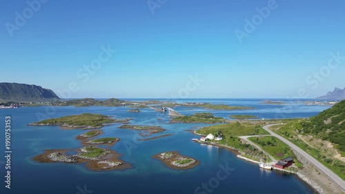 Aerial view of the coastal landscape near Fredvang in the Lofoten Islands of Norway, showing the distinctive Fredvang bridges. The Norwegian Sea is visible in the background.