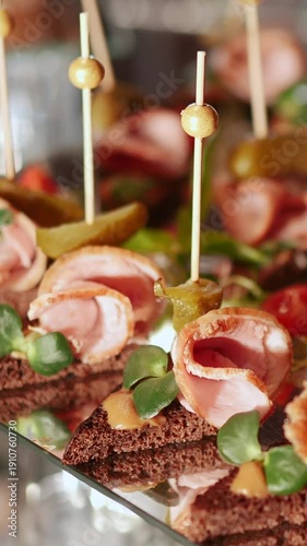 Catering service on banquet table with canape snacks in restaurant or hotel. Decorated food set on birthday, wedding celebration or business conference event venue