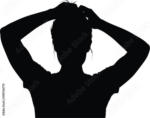 Woman adjusting hair in silhouette against a clean backdrop
