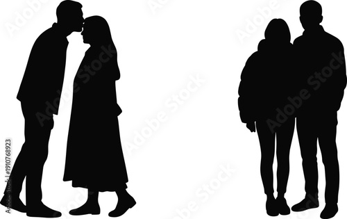 Silhouette of a romantic couple with man kissing woman on forehead and standing together wearing warm winter clothes for valentines day