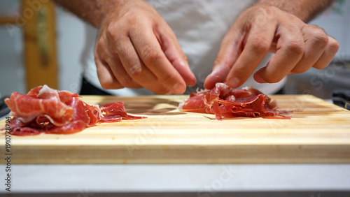 Quadro su tela Closeup of chef handling meat