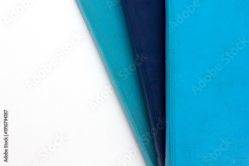 Close-up full frame photo of a stack of blue-covered Bibles, background and texture