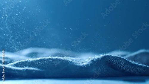 Subtle Fabric Movement Wide shot, gentle air current causing a delicate undulation of dusty fabric, catching blue light.