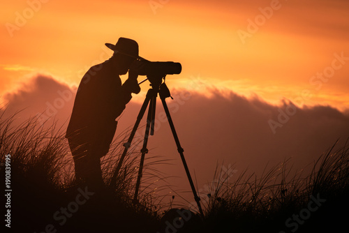 Canvas Print silhouette of a bird watcher as sunset begins