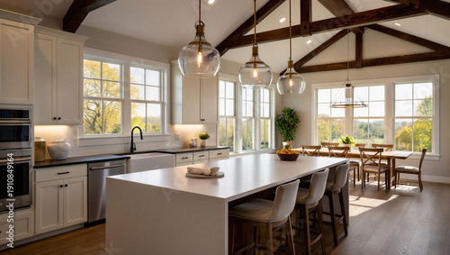 Billede på lærred Modern kitchen with island and dining area in a bright and airy house