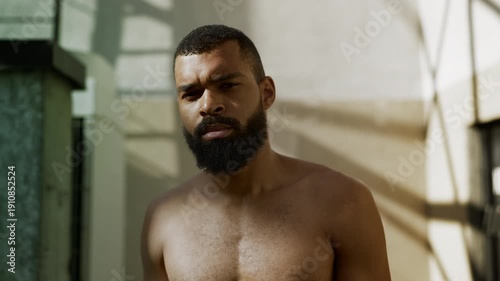 Wallpaper Mural Portrait of exhausted Black male boxer wiping sweat after rooftop workout Torontodigital.ca