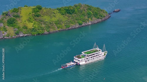 Boat exploring the dramatic karst landscape of Ha Long Bay, with emerald waters and towering rock pillars creating a breathtaking maritime panorama.