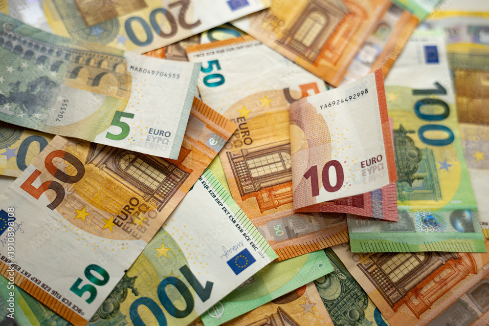 Obraz premium Scattered Euro Banknotes on Table, Money and Finance Concept, Euro Banknotes Spread on Table, Cash and Financial Concept