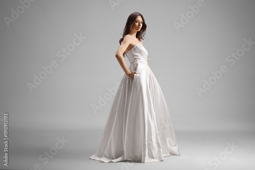 Woman wearing simple elegant strapless white satin ball gown
