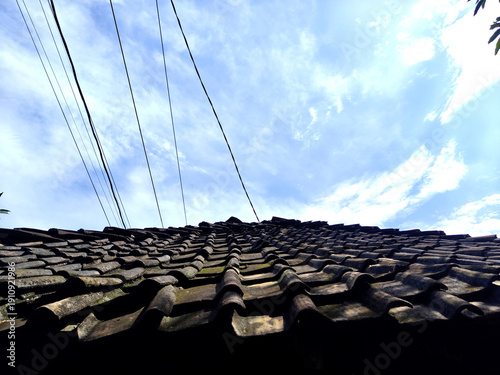 tile roof in blue sky background. Javanese traditional house.