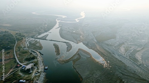 An aerial view shows the Brahmaputra River cutting through exposed sandbanks near Majuli during the dry season, reflecting low water levels, erosion, and the growing impact of climate change.
