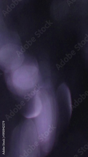 Flowing Vertical Bokeh Light Flash Transition, Abstract Purple Lighting Flowing Through Soft Bokeh Frames. suitable for spa story