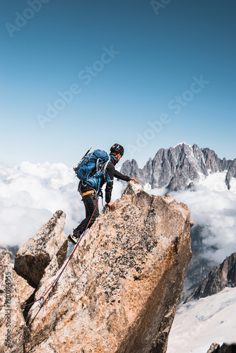 Elegant Mountaineer Walking Along Alpine Ridge with Rope, French Alps