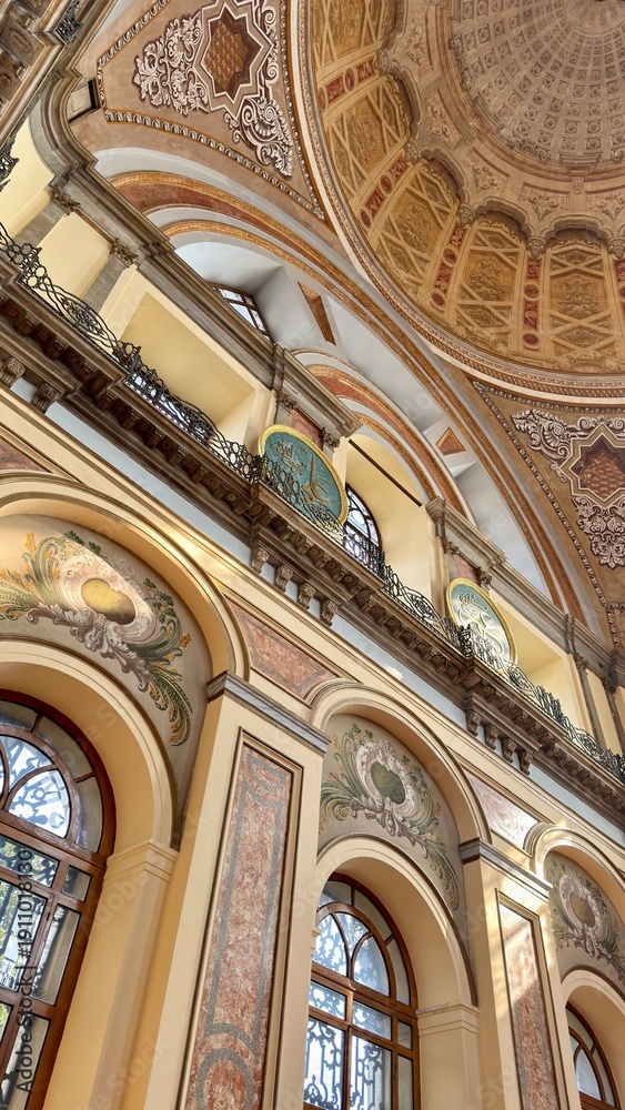 Fototapeta premium Interior of Dolmabahce Mosque in Istanbul during Ramadan. Elegant marble minbar and arched windows in Ottoman Baroque style. Peaceful spiritual atmosphere for Islamic prayer in the holy month.