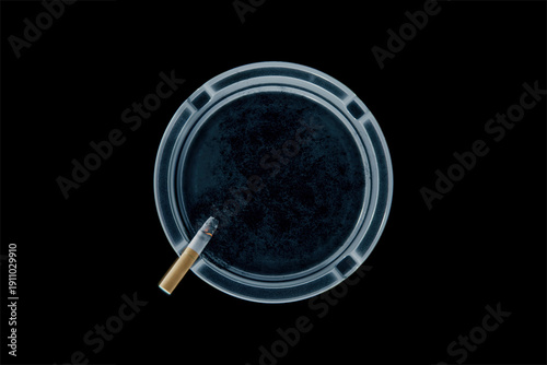 Fotografie Burning cigarette resting in an ash tray