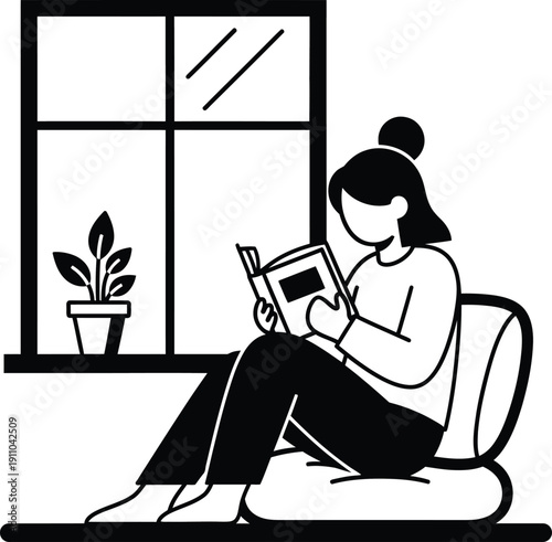 woman reading book sitting on chair by window