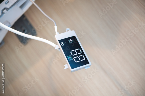 Close-up of digital air conditioner temperature controller during installation