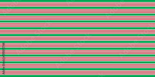 Christmas seamless pattern. Red and green diagonal stripes background. Candy cane repeating decoration wallpaper. Winter holiday lines backdrop. vector