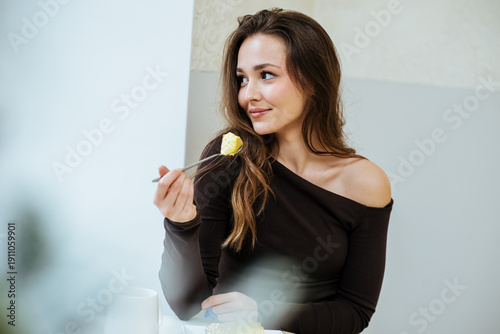Woman enjoys dessert in a b...